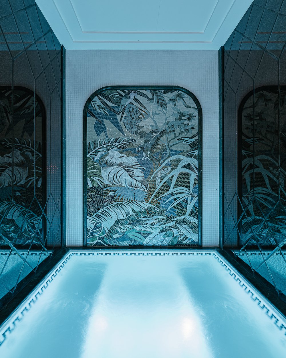 The Jacuzzi pool beneath arched foliage murals