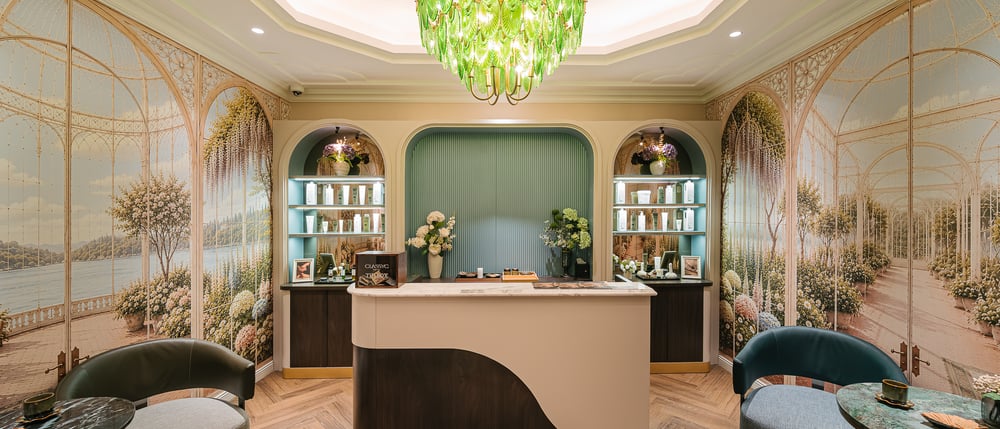 The SPA at Classyc reception desk beneath a green glass chandelier