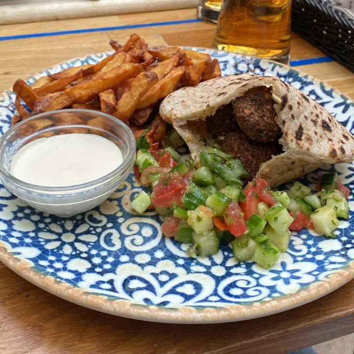 photo of Mazel Tov Fresh grilled pita stuffed with hummus, Israeli salad and crispy falafel. The plate comes with homemade potato chips and tahini. shared by @giuliagermani on  10 Jan 2024 - review
