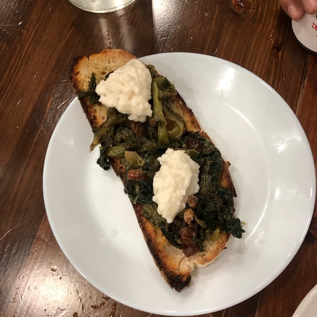 Photo of the dish “bruschetta con scarola, uvetta, pinoli e burrata di anacardi”