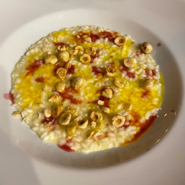Photo of the dish “Risotto Con Zafferano, Gel Di Melograno, Mozzarisella E Nocciole Tostate”