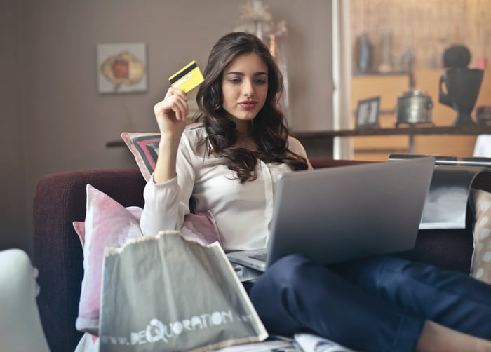 woman with a laptop using a credit card