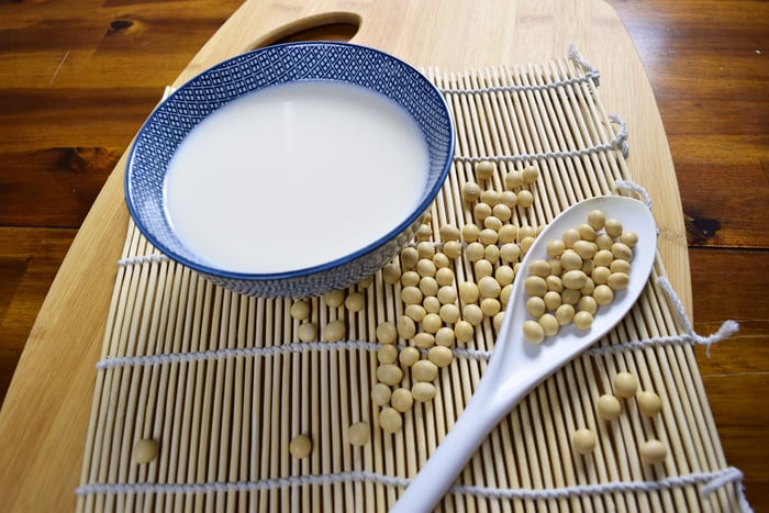 soy milk with soy in background