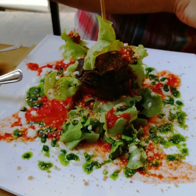 Photo of the dish “Parmigiana Di Melanzane, Mandorle E Pesto Di Rucola”