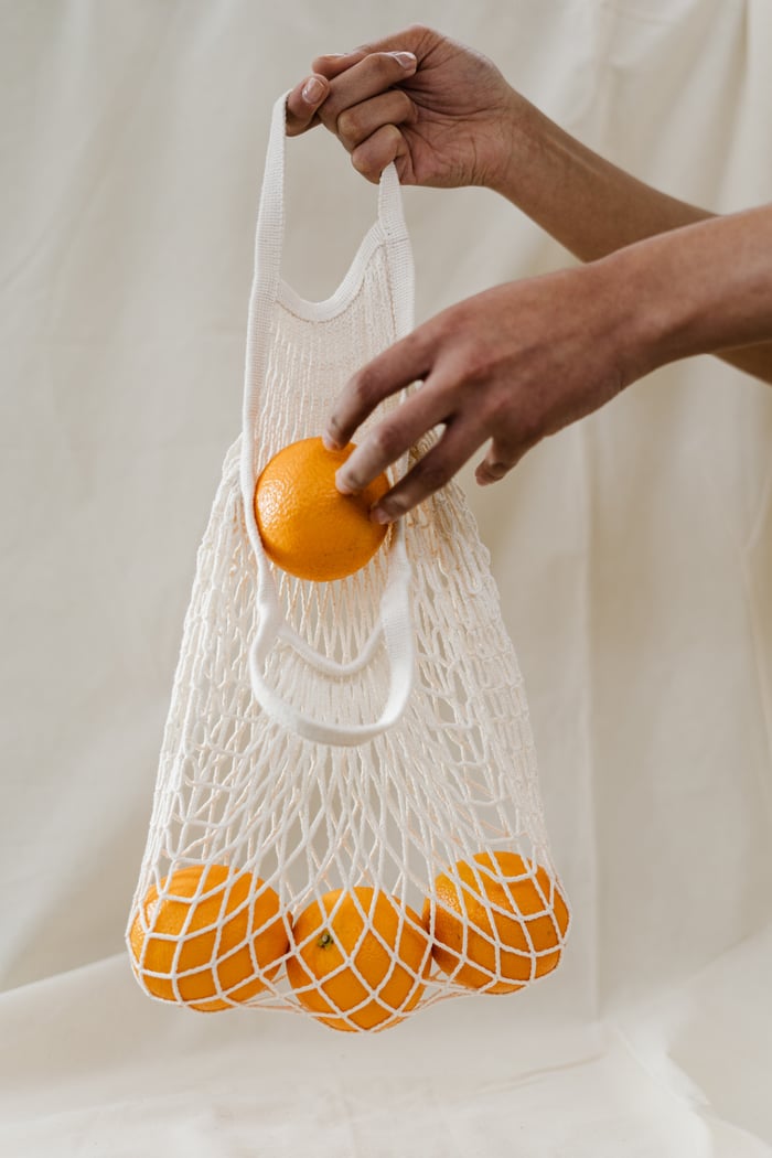 oranges in reusable bags
