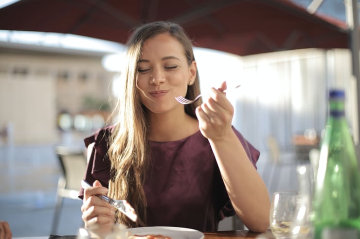 woman at a café enjoying her meal