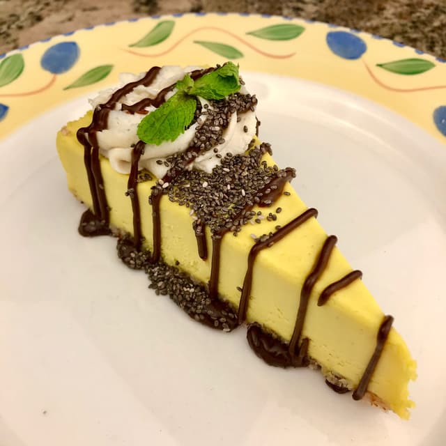 Photo of the dish “Passion Fruit Cheesecake Drizzled with Chocolate Sauce”