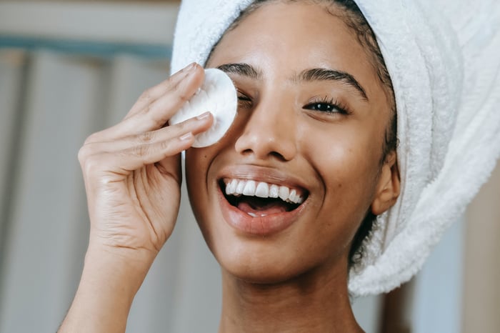 woman cleaning her face