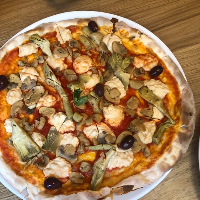 Photo of the dish “pizza carciofi e funghi con formaggio veg”