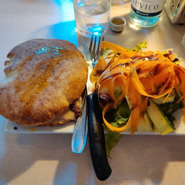 Photo of the dish “puccia (wood-fired panino) with cannellini bean cream, chicory puntarelle and patè of taggiasche olives”