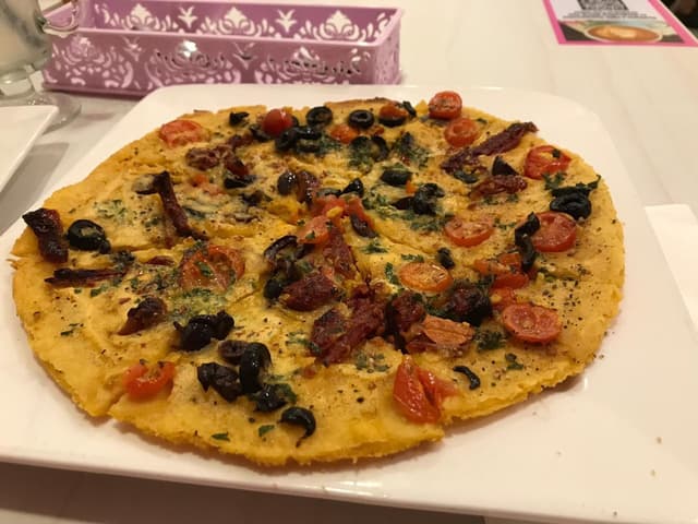 Foto do prato “Farinata with sundried tomatoes and olives”