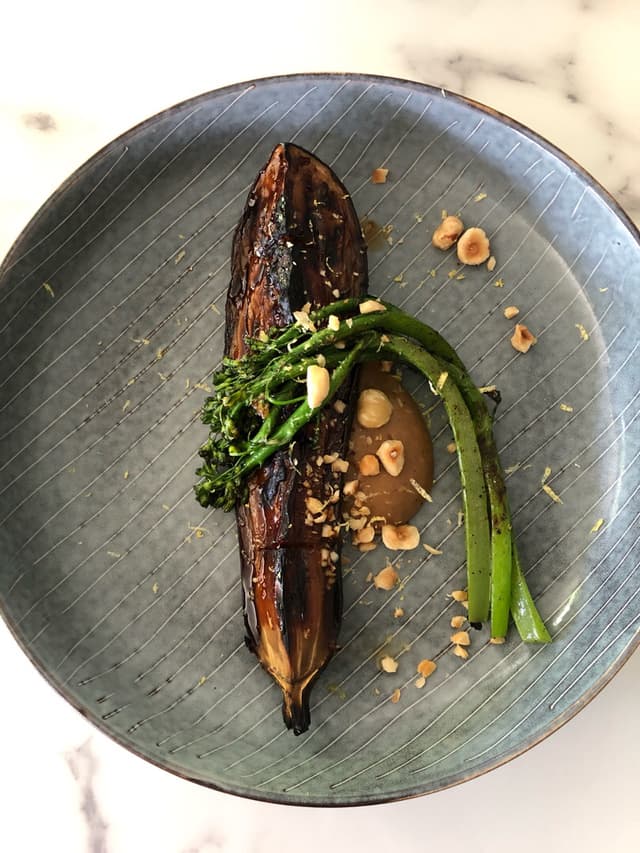 Photo of the dish “Grilled miso eggplant with broccolini, onion puree, hazelnuts”