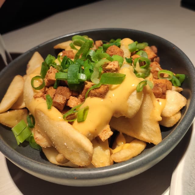 Photo of the dish “French Fries With Vegan Cheese Sauce And Smoky Tofu”
