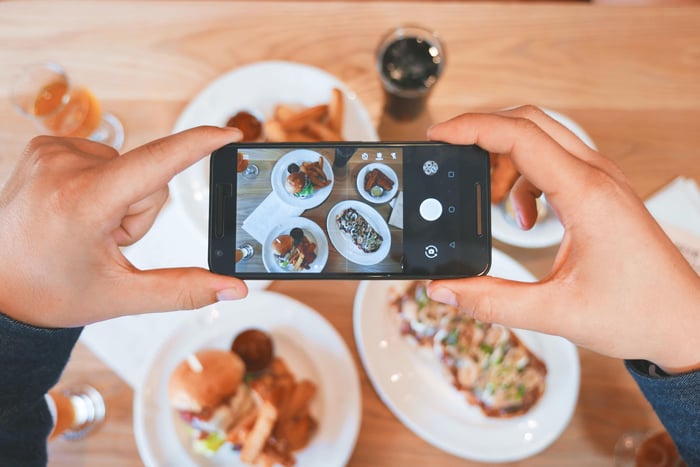 person taking a photo of food