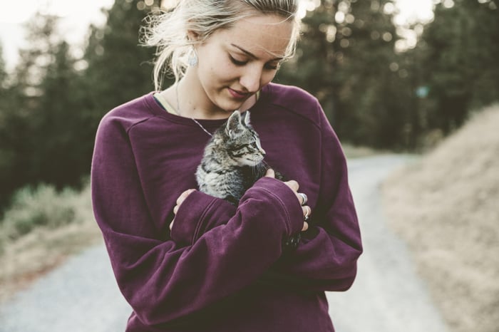 woman cuddling a cat