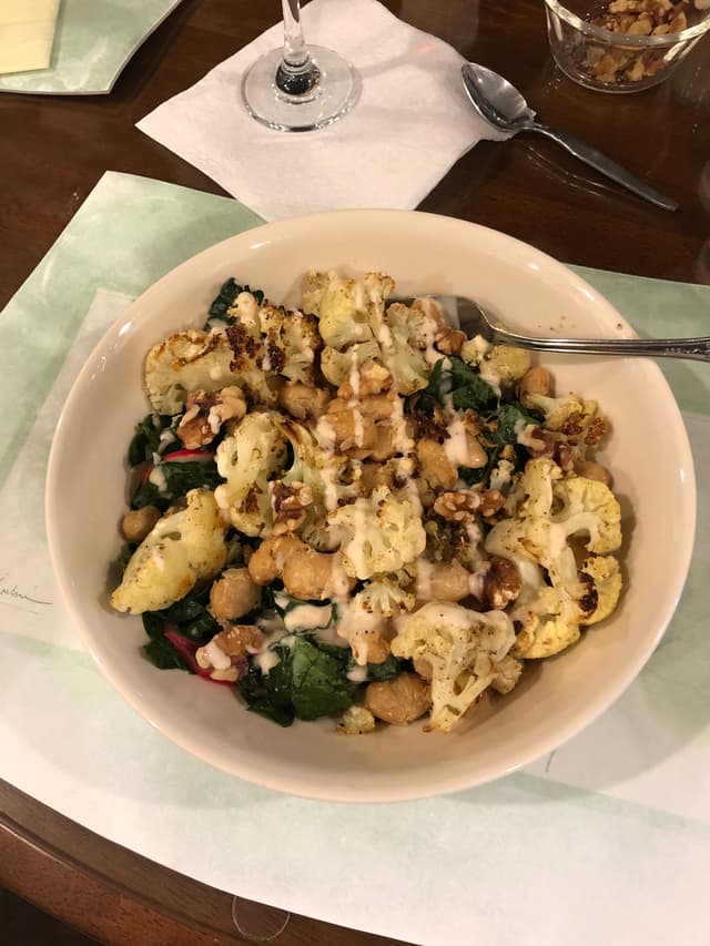 Photo of the dish “CAULIFLOWER KALE CAESAR with Crispy Butter Beans & Walnuts”