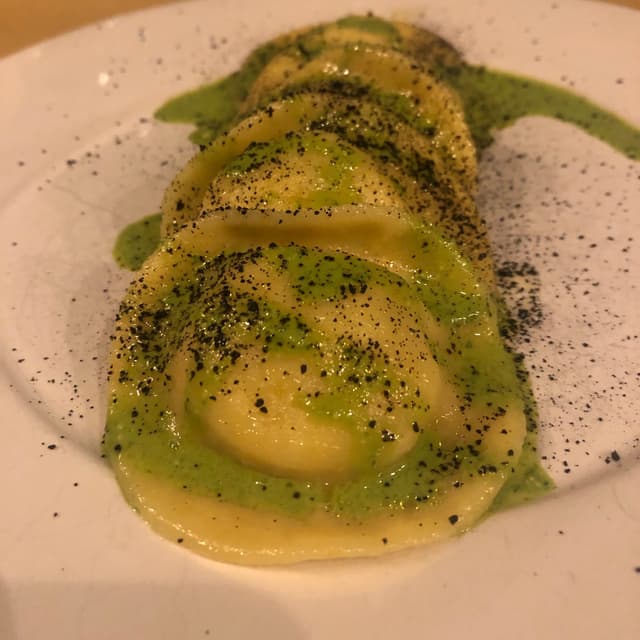 Photo of the dish “Pasta Ripiena Con Ricotta Di Canapa, Salsa Al Basilico E Aglio Nero”