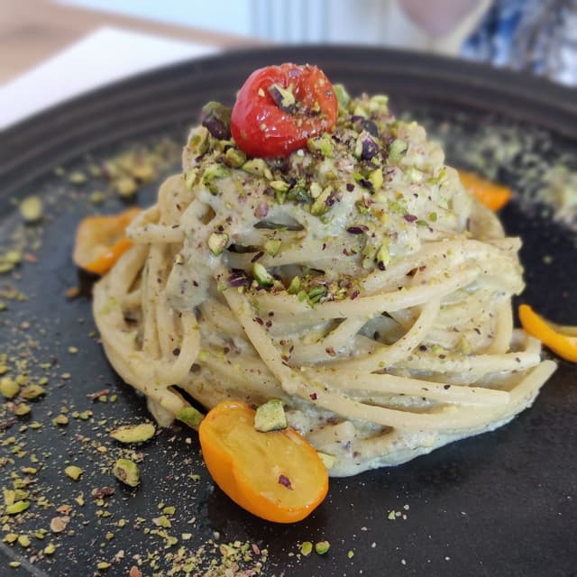 Photo of the dish “Spaghettoni al pesto di pistacchio e ciliegini gialli”