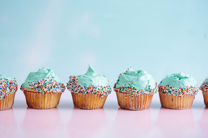 row of vegan cupcakes with pastel background