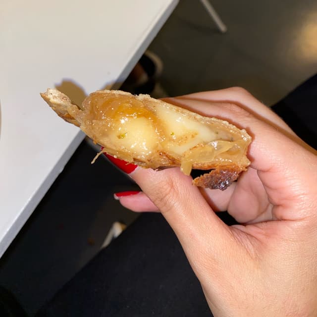 Photo of the dish “Empanada de cebolla caramelizada y queso”