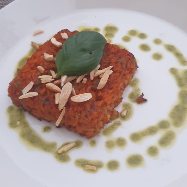 「Tortino Di Riso Al Pomodoro E Basilico Con Mandorle」の料理の写真