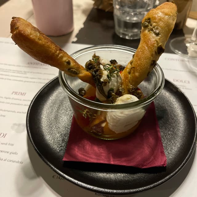 Photo of the dish “Ricotta di mandorle ai sapori mediterranei, pomodorini confit, capperi fritti con frustina di pane alle olive”