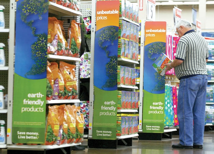 man standing before a green panel in a shopping mall