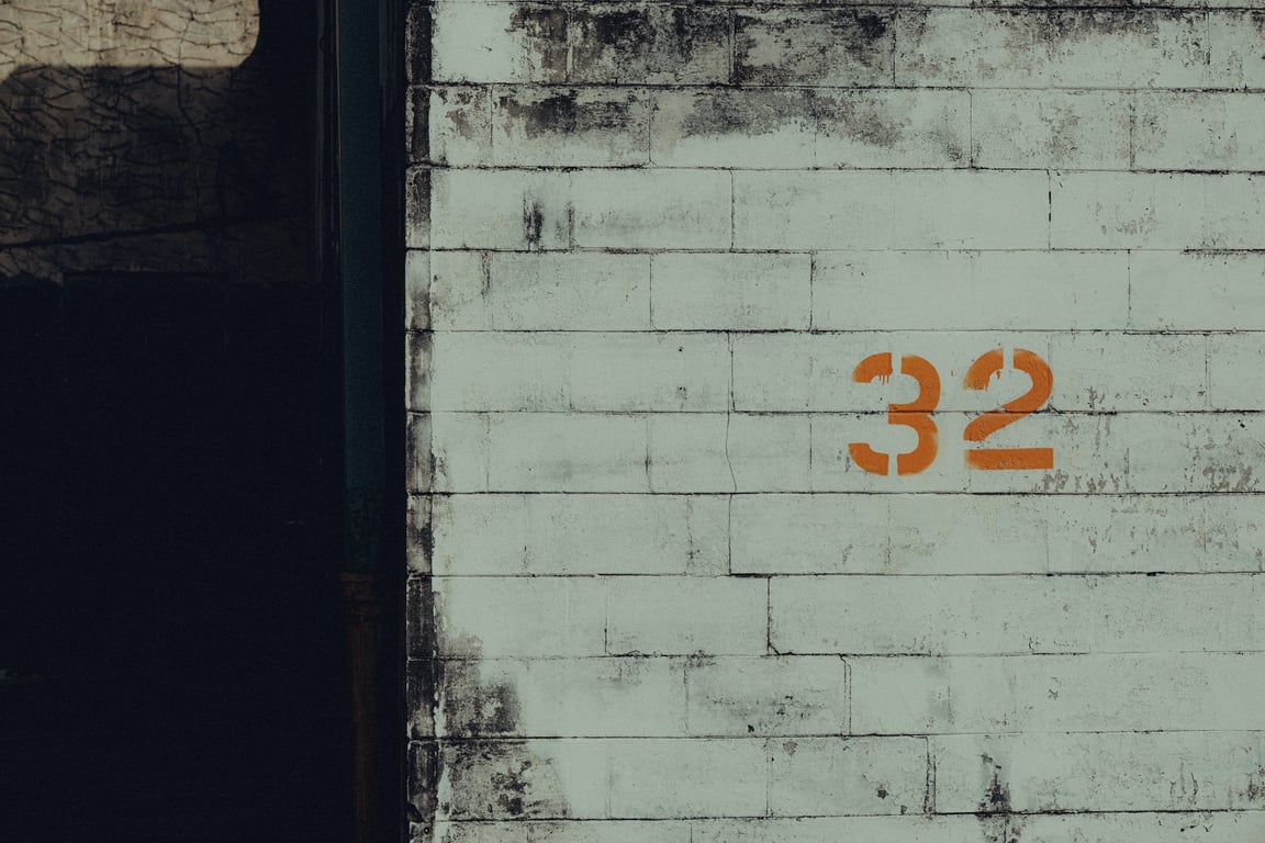 Number 32 Painted on White Brick Wall - By ALTEREDSNAPS via Pexels.com