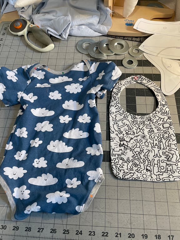 An Otis baby romper and Bob bib