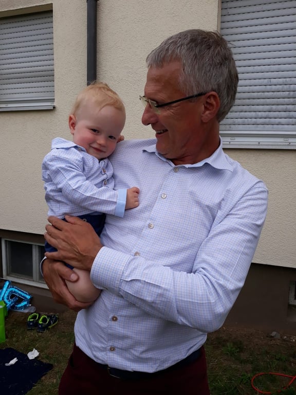 Stefan wearing Simon shirt, holding his grandson