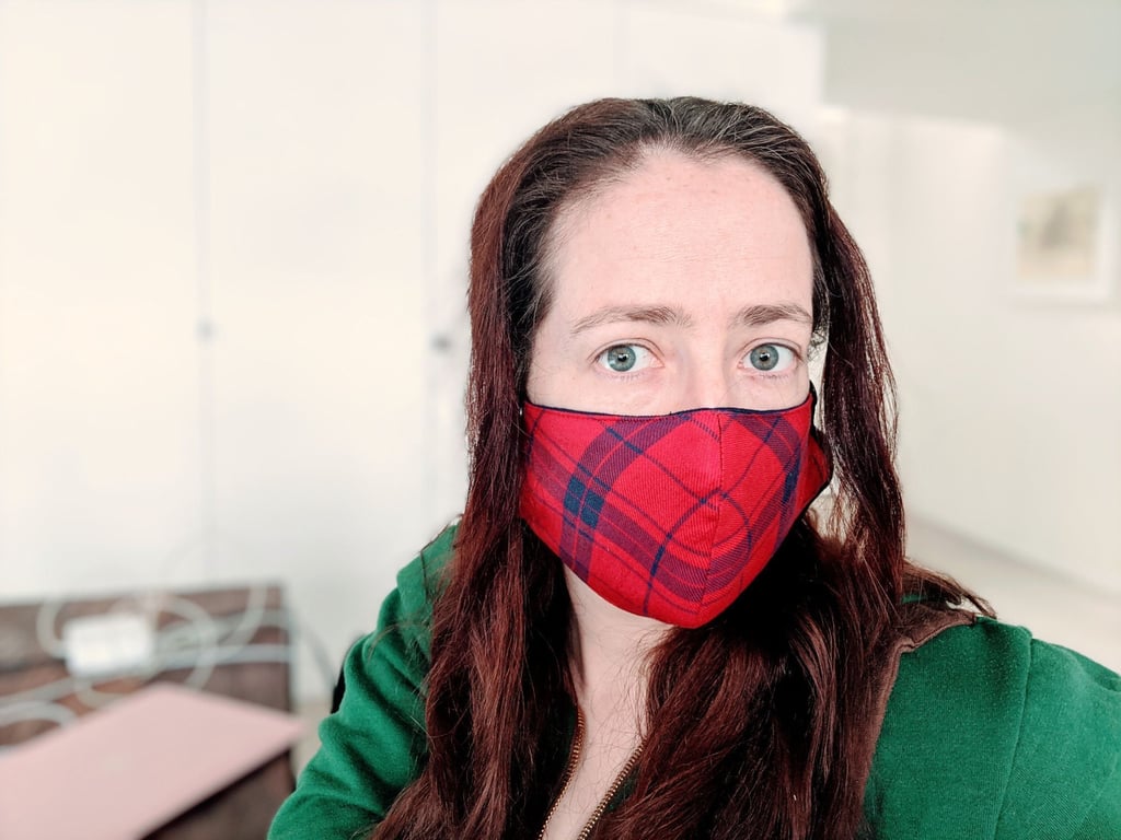 Sorcha wears a red and blue tartan Florence face mask
