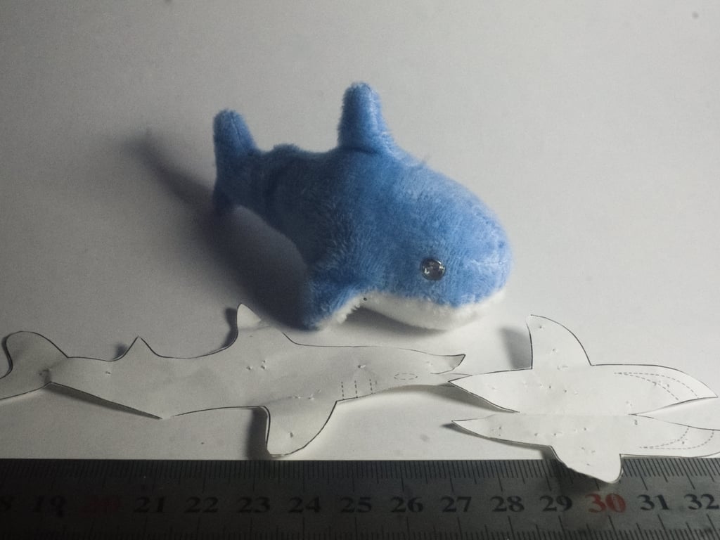 A small blue shark plush, about 10cm in size