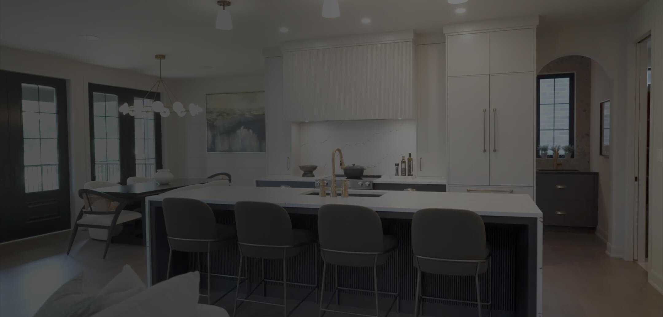 Warm dark modern kitchen with white cabinetry, a central island, pendant lighting, and bar seating—built for daily life and shared family dinners.