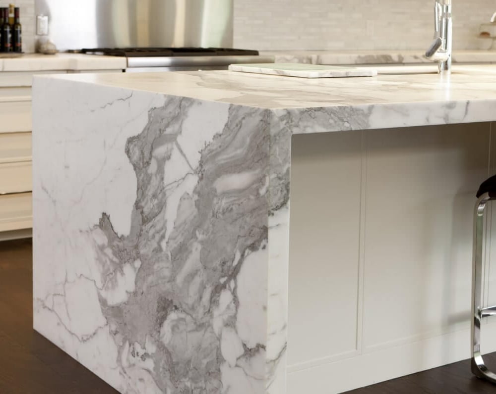 Project_Kitchens_Old+Colonial+Acres2 Marble kitchen island with a smooth surface and a modern design, featuring gray and white veining patterns.