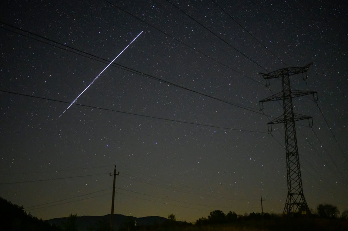 A long exposure shows a string of SpaceX Starlink satellites passing over Salgotarjan, Hungary, 12 May 2021. Photo: EPA / Peter Komka