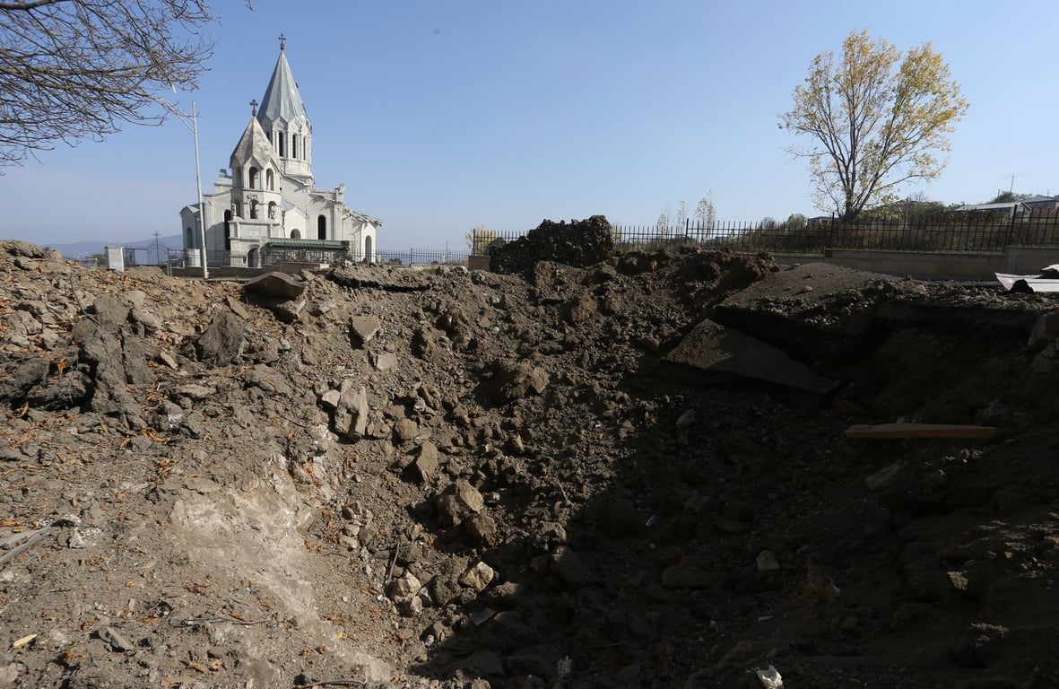 An Armenian church in the town of Shushi, Nagorno-Karabakh, overlooks a crater caused by Azerbaijani shelling, 29 October 2020. Photo: EPA / HAYK BAGHDASARYAN /PHOTOLURE
