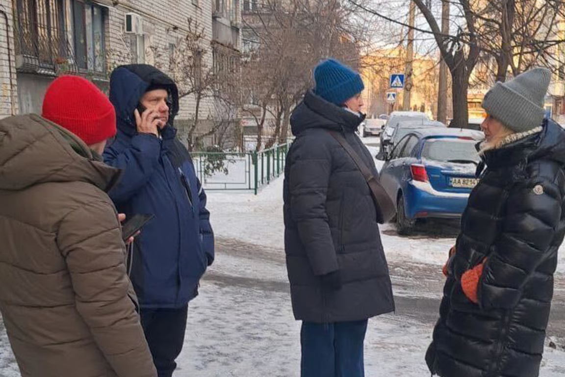 Baba Zhenya’s concerned neighbours gather outside her apartment building.