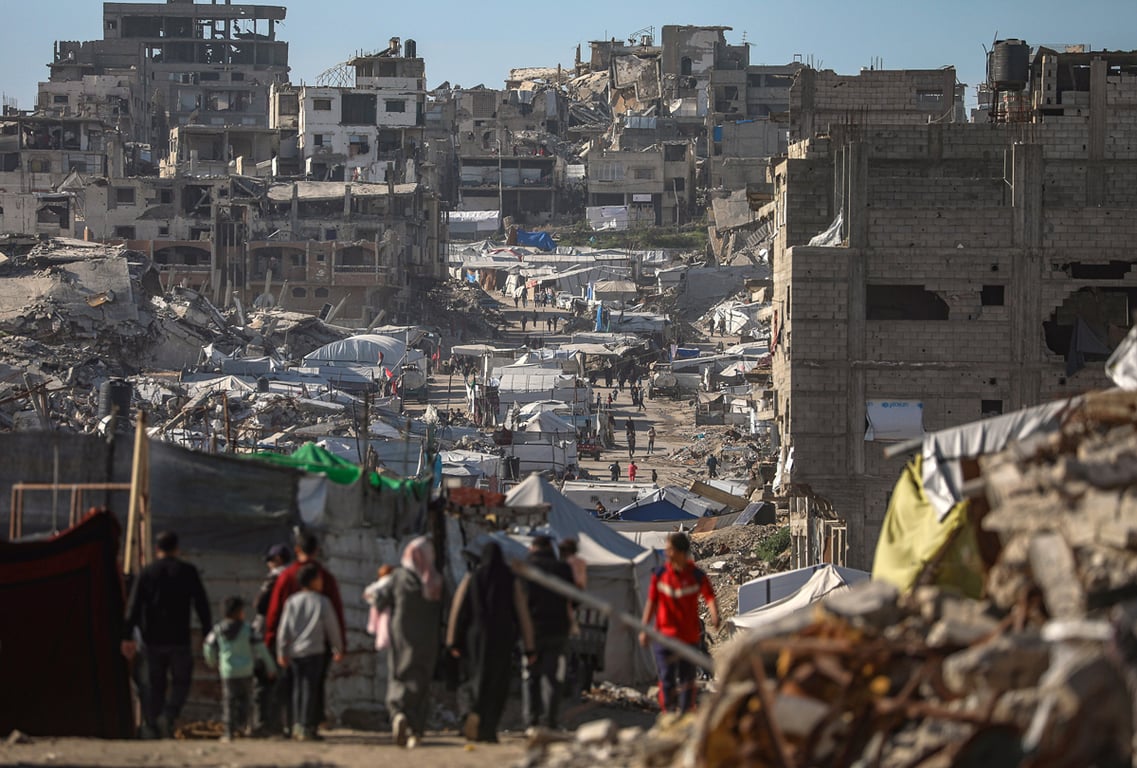 Внутренне перемещенные палестинцы идут среди руин района Аль-Туффа в восточной части города Газа, 11 февраля 2026 года. Фото: Mohammed Saber / EPA