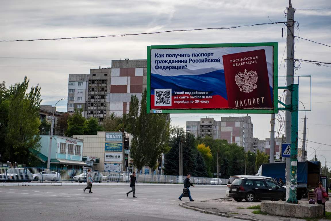 A propaganda billboard promotes Russian citizenship in Luhansk, Ukraine, 22 September 2022. Photo: AP Photo / Scanpix / LETA
