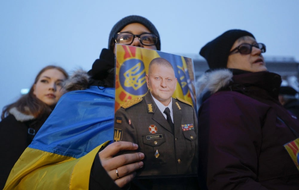 A woman holds a picture of former commander-in-chief of the Armed Forces of Ukraine, Valeriy Zaluzhnyi, during a rally supporting him on Kyiv’s Independence Square, 9 February 2024. Photo: EPA / SERGEY DOLZHENKO