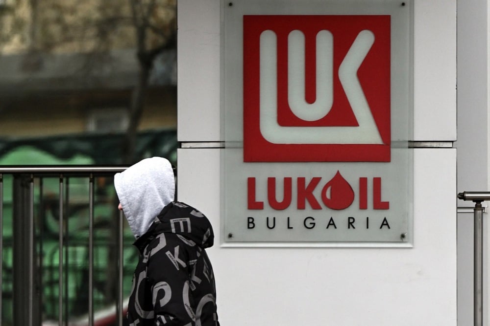A man walks past the logo of Russian oil company Lukoil in Sofia, Bulgaria, 7 December 2023. Photo: EPA/VASSIL DONEV
