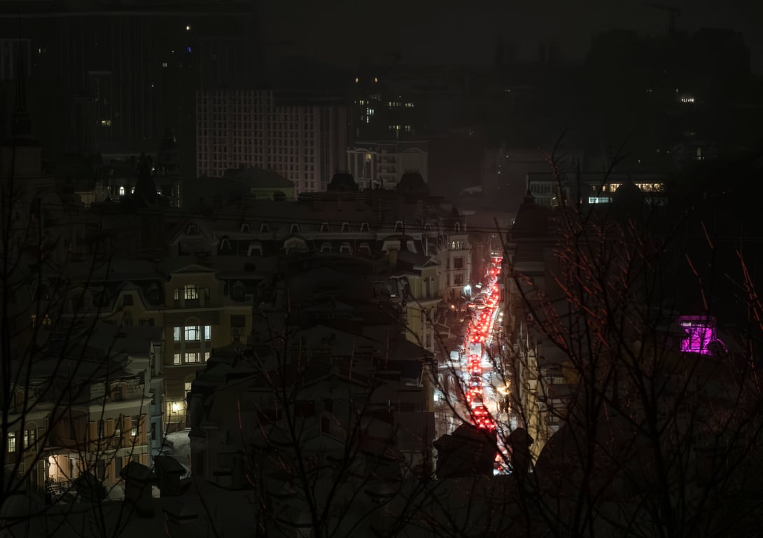 Car lights illuminate an otherwise dark Kyiv, as much of the Ukrainian capital was left without power following intensive Russian airstrikes on the city’s energy infrastructure, 13 January 2026. Photo: EPA / Maxym Marusenko