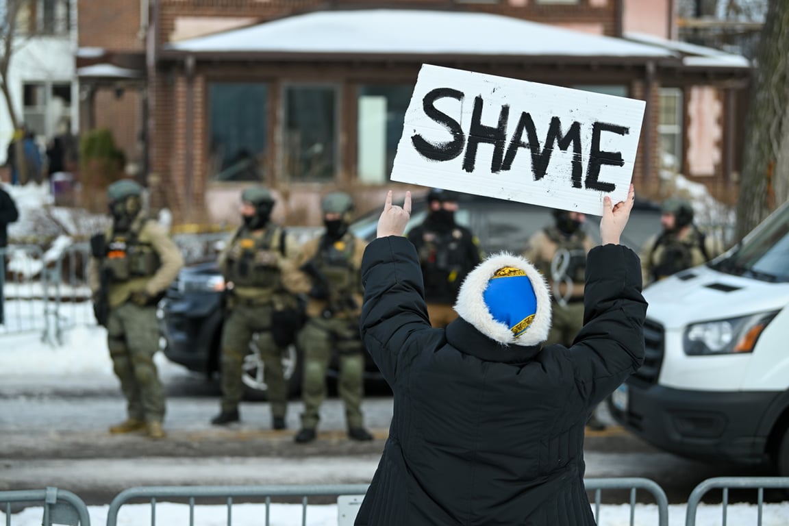Протестующий с плакатом на месте гибели женщины, застреленной агентом Иммиграционной и таможенной полиции (ICE) в Миннеаполисе, Миннесота, США, 7 января 2026 года. Фото: Craig Lassig / EPA