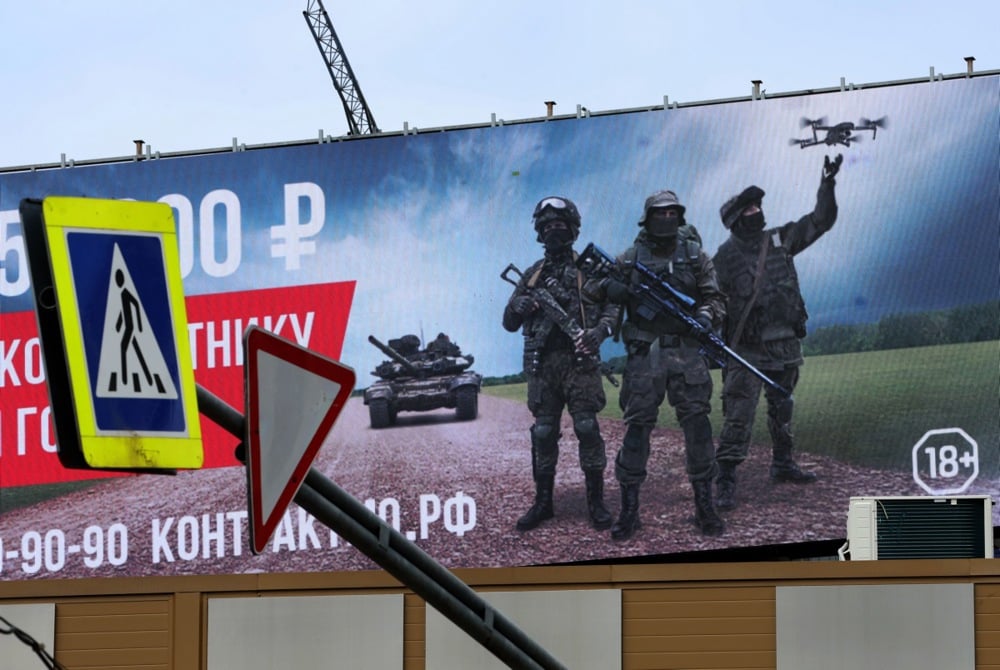 An electronic screen displays an advertisement calling for military conscription featuring images of Russian soldiers in Moscow, Russia, 26 August 2025. EPA/MAXIM SHIPENKOV