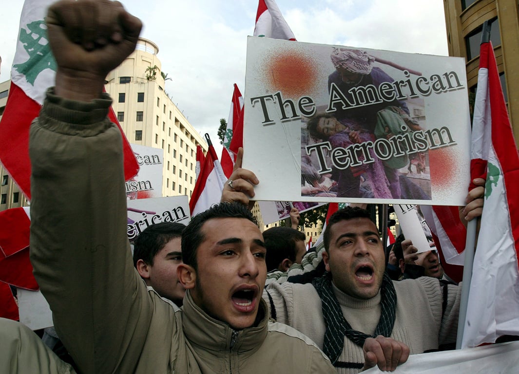 Ливанские демонстранты из движения «Хезболла» и других просирийских ливанских партий протестуют против визита помощника госсекретаря США Дэвида Уэлча в Ливан перед правительственным дворцом в Бейруте в субботу, 14 января 2006 года. Фото: Nabil Mounzer / EPA