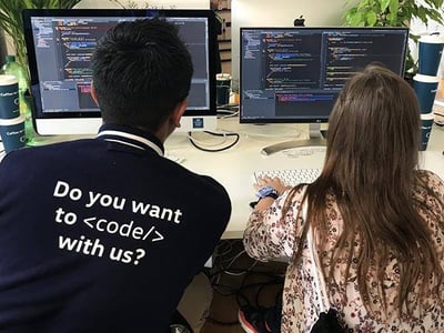 Attendees coding side-by-side at the venue.