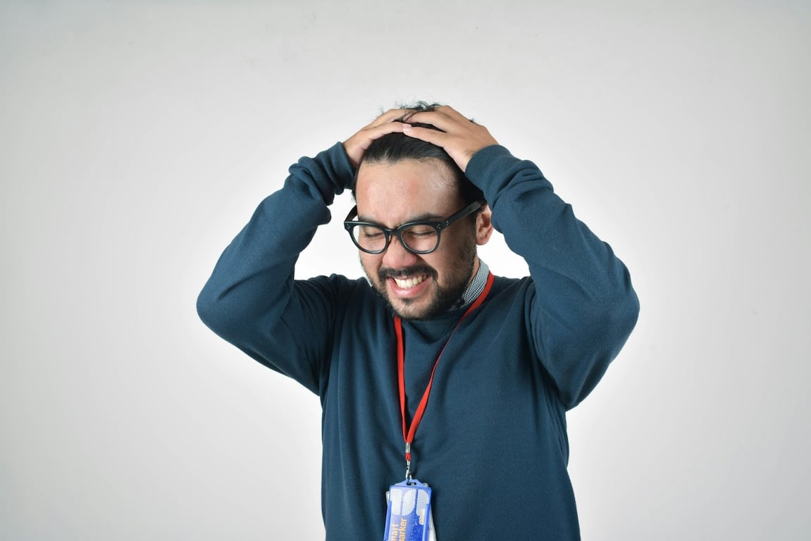 A recruiter stands with their hands on their head frustrated