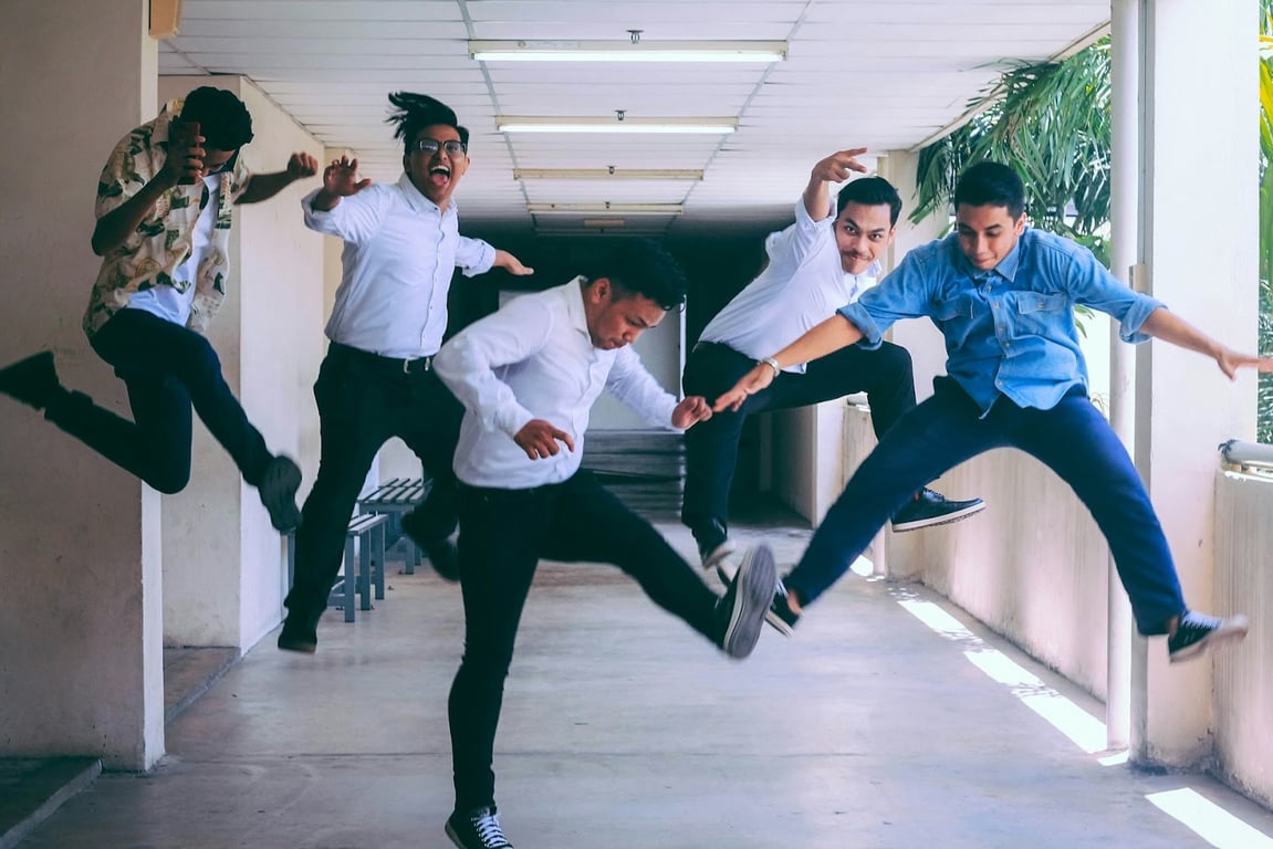 A group of happy employees jumping in the air, freeze-framed, for joy