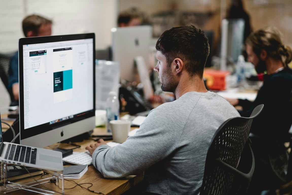 A tech employee working passively in the office after a strict RTO policy has been enforced