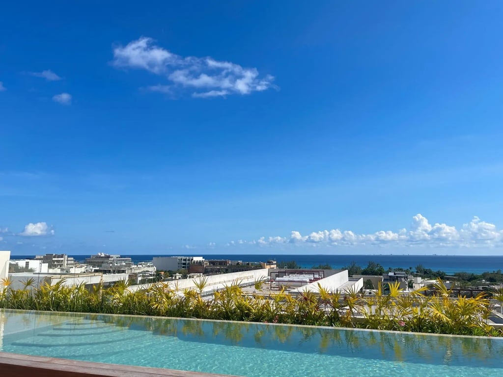 Modern Downtown Playa del Carmen Condo with Rooftop Pool and Caribbean Views